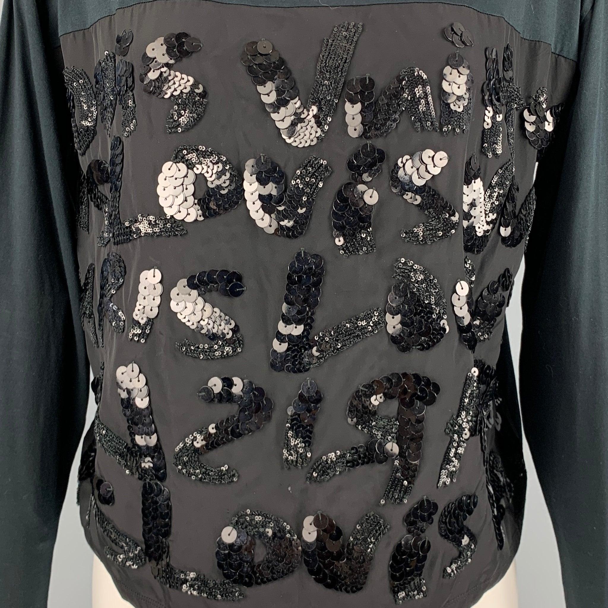 STEPHEN SPROUSE x LOUIS VUITTON dress top in a black fabric featuring mixed fabrics, sequin embroidered front, long sleeves, and a crew neck. Made in Italy.Excellent Pre-Owned Condition. 

Marked:  XS 

Measurements: 
 
Shoulder: 18.5 inches Bust: