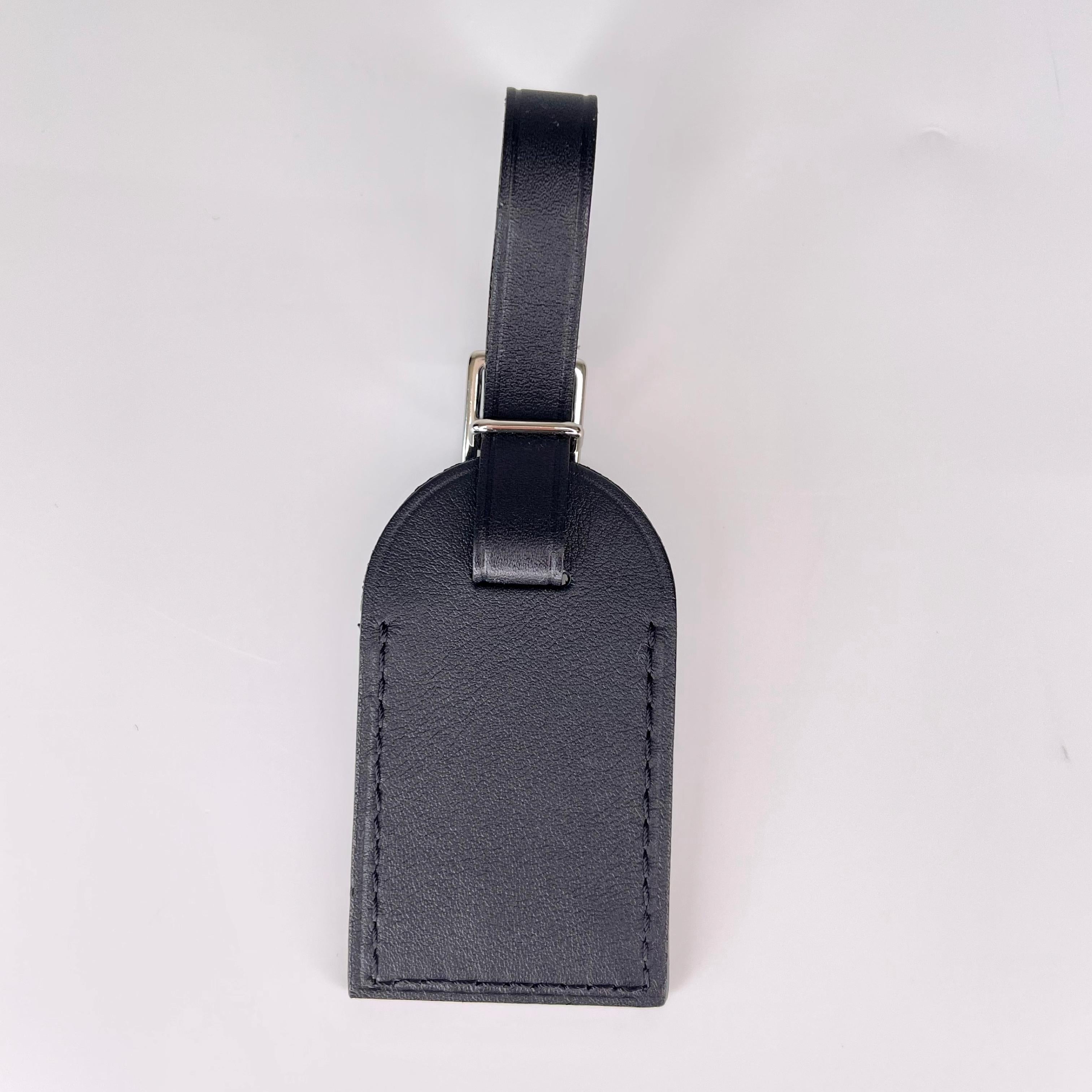 This Louis Vuitton luggage tag is small, chic and a great travel accessory. Made of calfskin leather, and remains in very good condition.

COLOR: Black
MATERIAL: Calfskin
MEASURES: L 2.5” x W 1.5”
COMES WITH: Dustbag, orange box, care