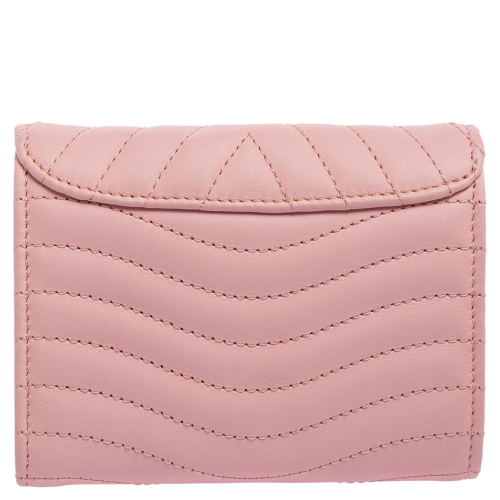 Louis Vuitton's collection of exquisite, functional designs includes this New Wave compact wallet. Made from smoothie pink leather, the wallet brings a quilted design, front LV logo, and multiple slots to carry your cash and cards.

Includes: