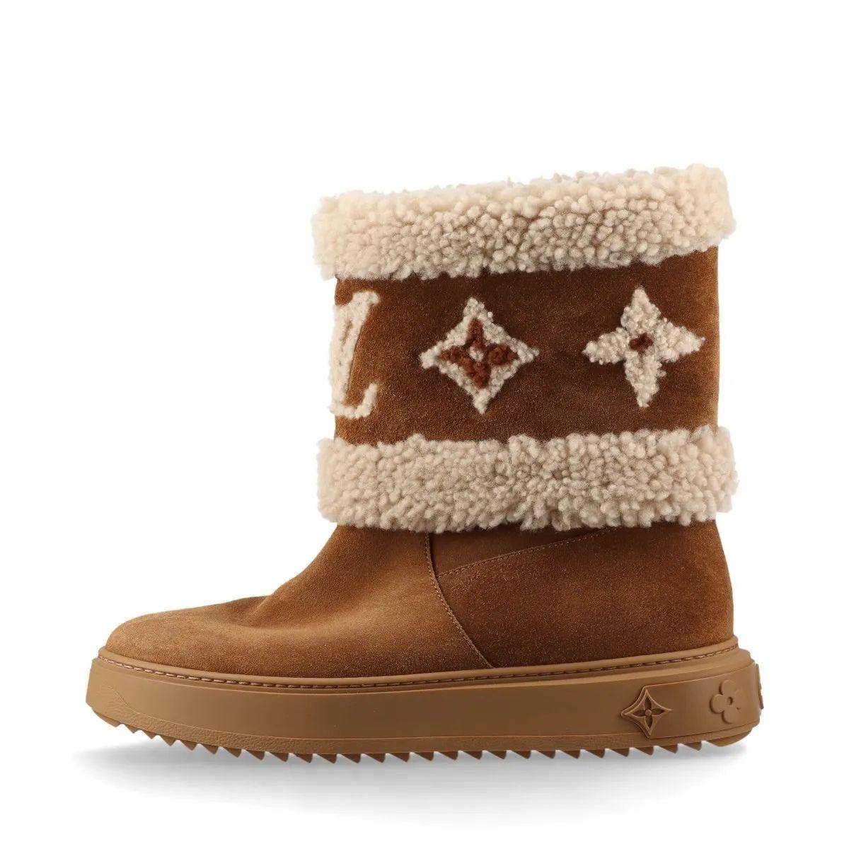 Die Louis Vuitton Monogram Snowdrop Suede Ankle Boot ist eine flache Stiefelette aus Kalbsveloursleder und Shearling, ein gemütlicher, komfortabler Stil, der ideal für Reisen und kaltes Wetter ist. Der Kragen aus Shearling ist mit einem übergroßen
