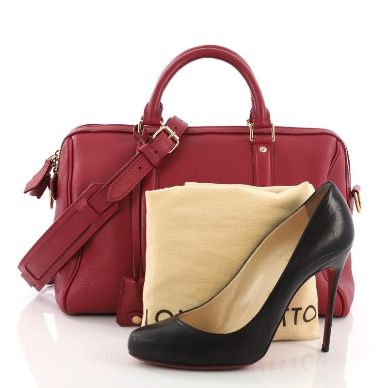 This Louis Vuitton Sofia Coppola SC Bag Leather PM, crafted from red leather, features dual rolled handles, protective base studs and gold-tone hardware. Its two-way zip closure opens to a gray suede interior with side zip and slip pockets.