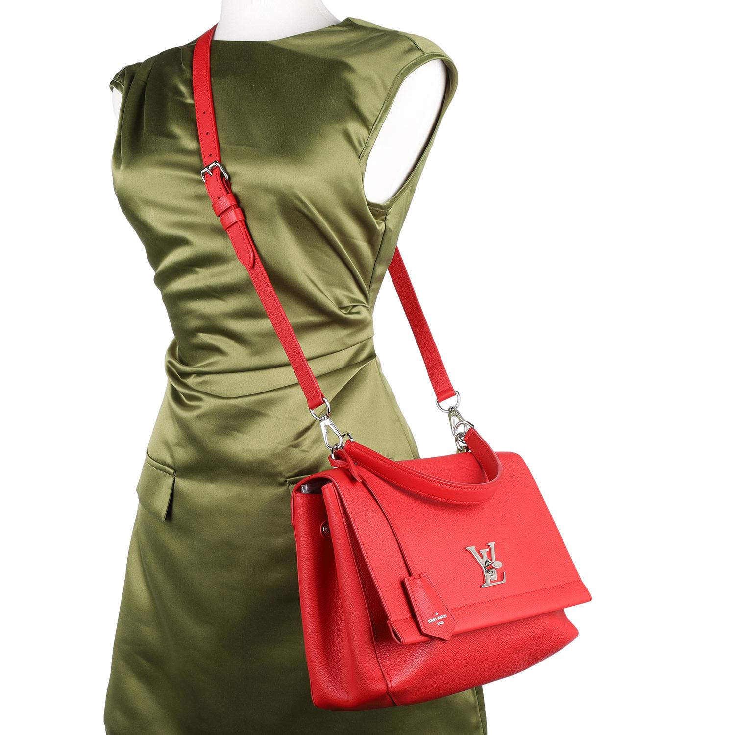 Authentic Louis Vuitton Soft Calfskin Lockme II Top Handle Rubis Crossbody Bag.

Features Louis Vuitton grained calfskin leather in red, top handle, silver hardware, an optional adjustable leather shoulder strap, front  flap closue with twist lock,