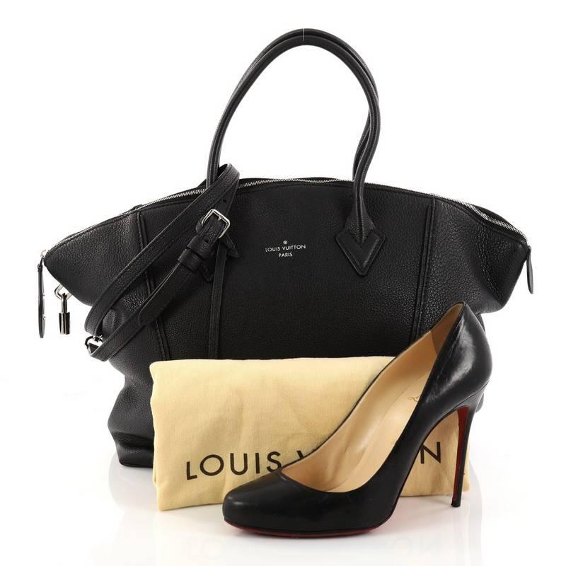 This authentic Louis Vuitton Soft Lockit Handbag Leather MM first introduced in 1958, is re-imagined with modern and understated, clean lines showcasing the brand's ever-evolving style. Crafted from black taurillion leather, this chic tote features