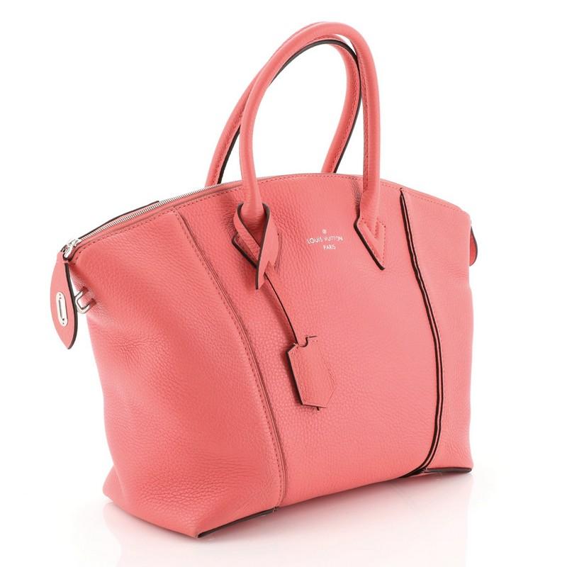 This Louis Vuitton Soft Lockit Handbag Leather MM, crafted in pink leather, features dual-rolled handles, curved top, silver LV padlock on its side, and silver-tone hardware. Its top zip closure opens to a veau velours interior with zip and slip