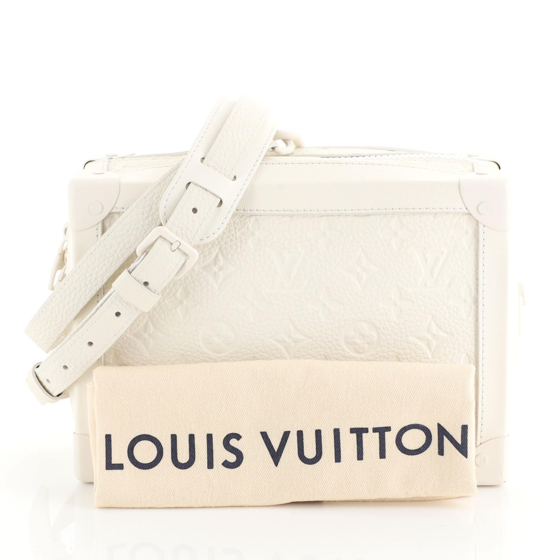 This Louis Vuitton Soft Trunk Bag Monogram Taurillon, crafted from white monogram leather, features an adjustable leather strap and silver-tone hardware. Its zip closure opens to a black fabric interior with slip pockets. Authenticity code reads: