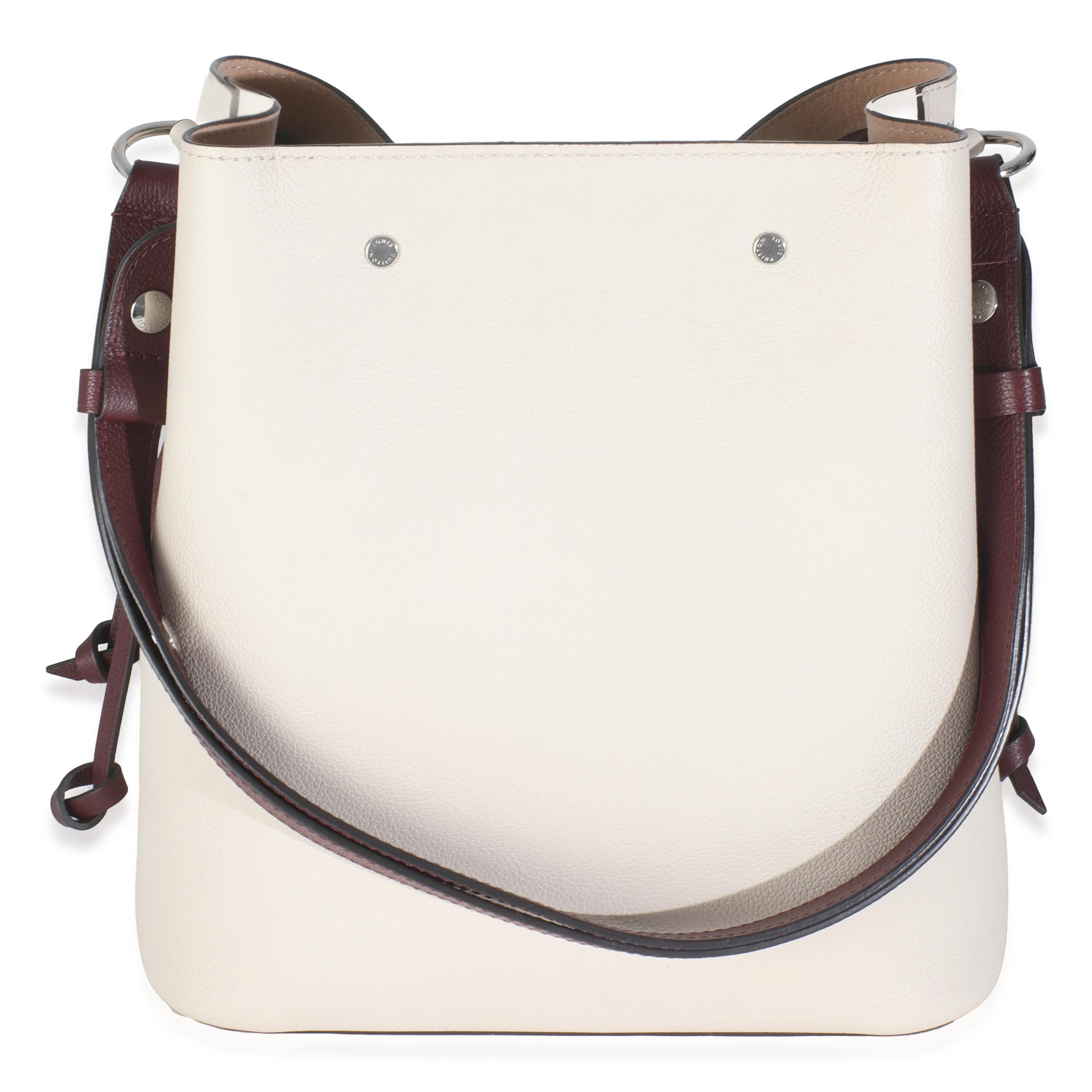 Listing Title: Louis Vuitton Soie Quartz Calla Calfskin Lockme Bucket Bag
SKU: 145343
Condition: Pre-owned 
Condition Description: The Lockme designs from Louis Vuitton get their name from the turn-lock closure that features on the LV logo plaque.