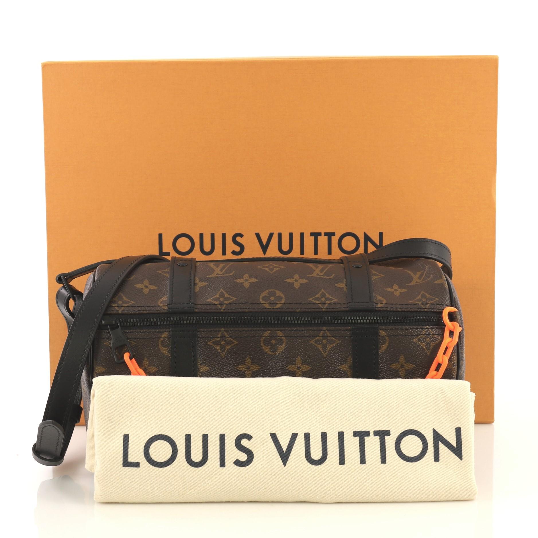 This Louis Vuitton Solar Ray Papillon Messenger Monogram Canvas Mini, crafted with monogram coated canvas and black leather, features an adjustable leather strap, leather trim, matte orange chain, and black-tone hardware. Its zip closure opens to a