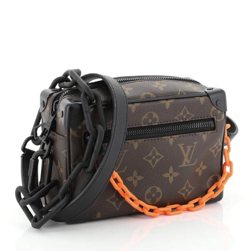 This Louis Vuitton Solar Ray Soft Trunk Bag Monogram Canvas Mini, crafted from brown monogram coated canvas, features flat leather strap, leather trim, matte orange chain and black-tone hardware. Its zip closure opens to a black fabric interior with