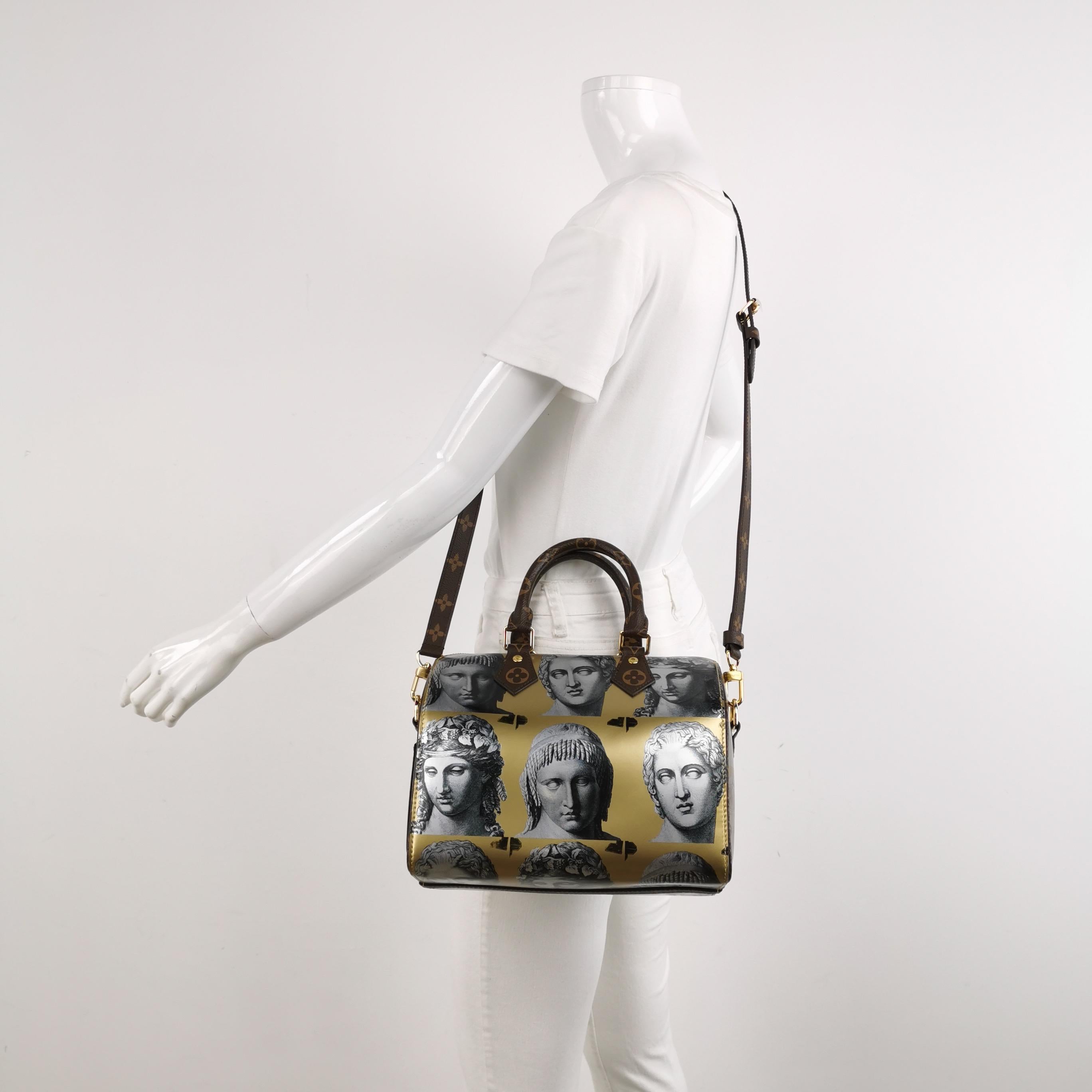 Louis Vuitton limited edition Fornasetti collection designed by Nicolas Ghesquière. Sold out worldwide speedy bandouliere 25 cm in printed patent leather, gold metal hardware and vuitton coated canvas monogram details.

CONDITION: MINT LIKE