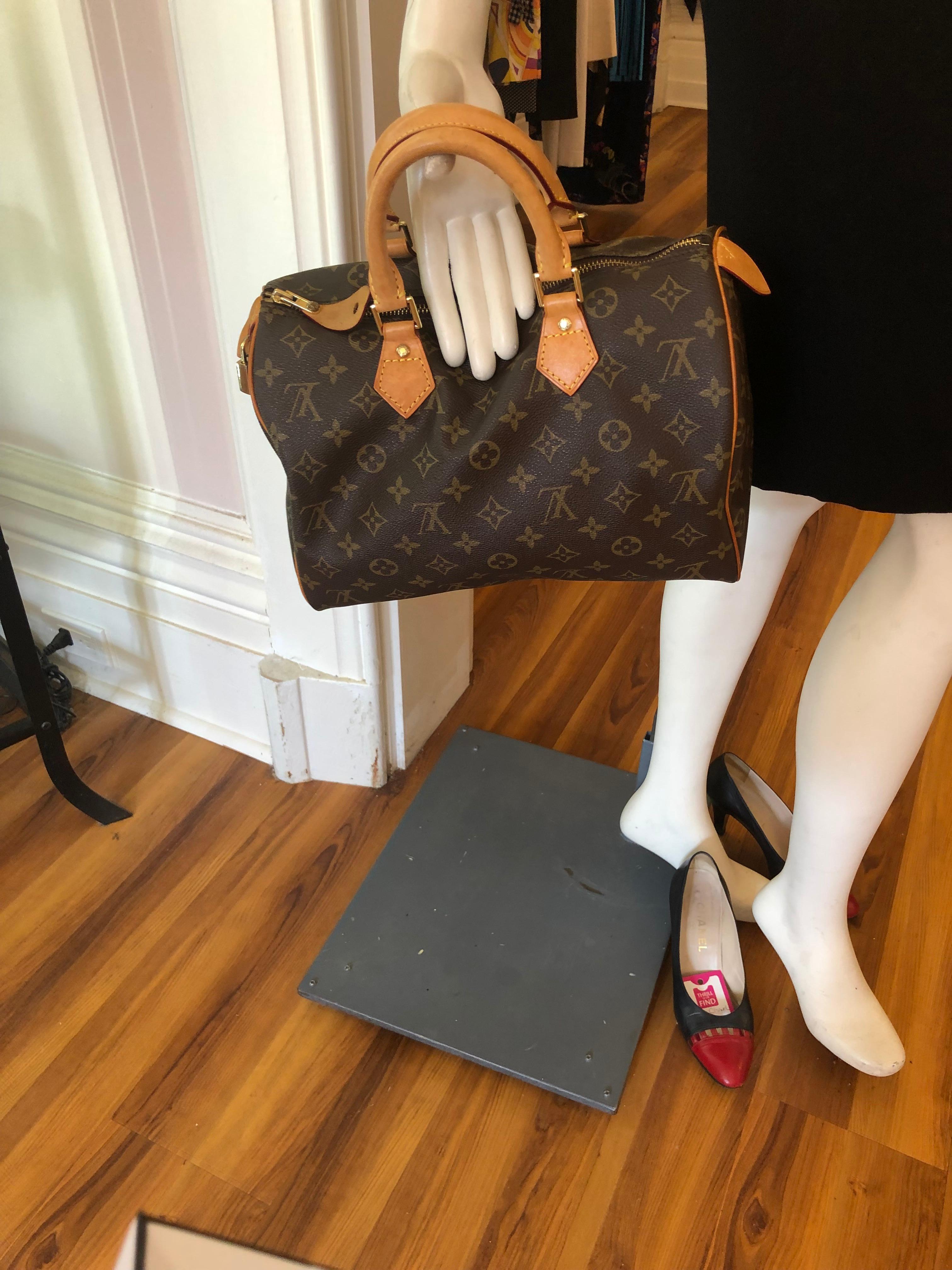 Made in France in March 2001 (AR0031), this LV Speedy 30 monogram canvas with vachetta leather is nice size bag, and can function as a carry all. The brown textile lining has an open pockets for small items and a Dring. The top handles are rolled;