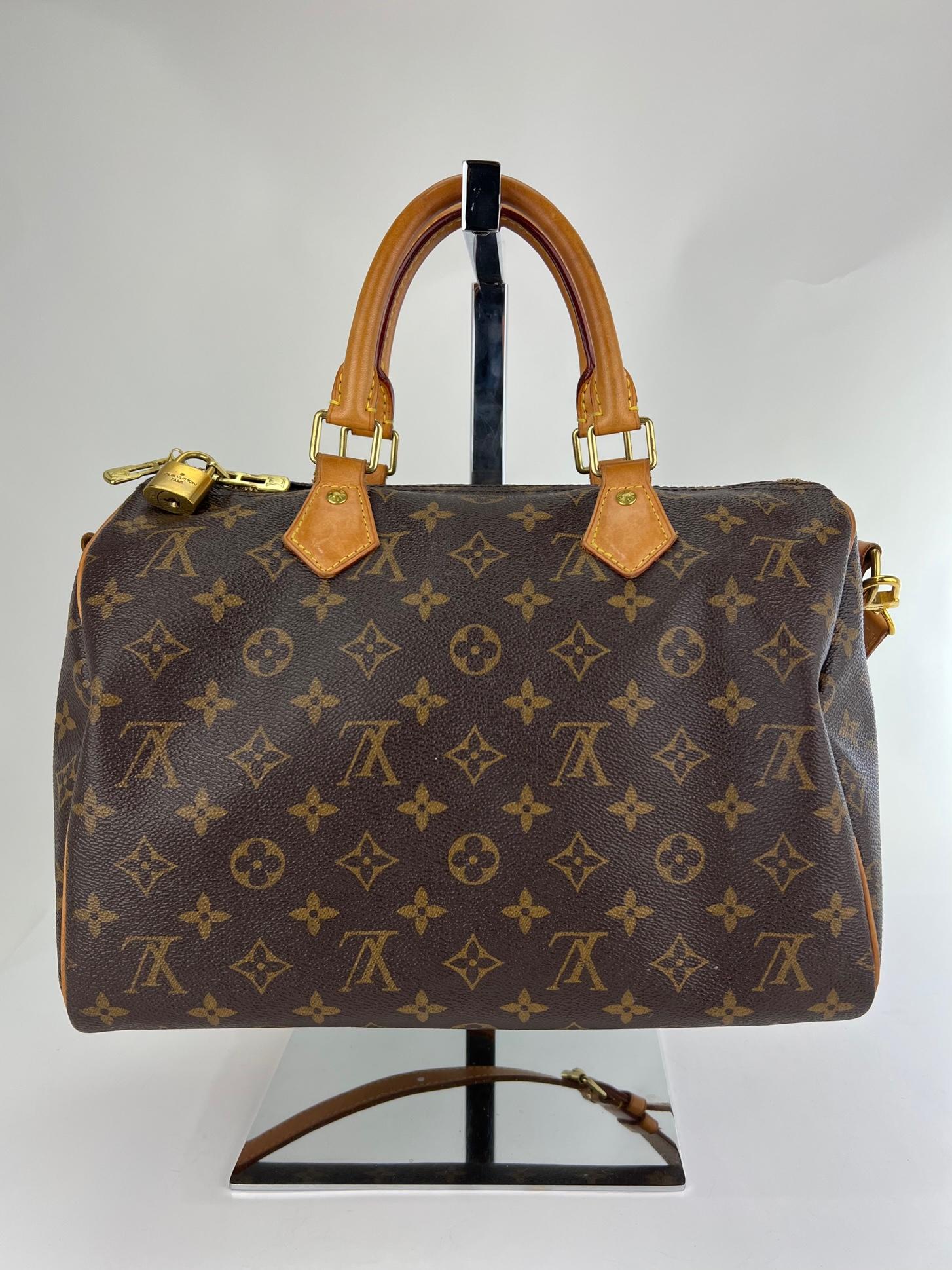 Preowned 100% Authentic
Louis Vuitton Speedy Bandouliere 30 Monogram
W/added insert to help keep its shape and organize
RATING: B   very good, well maintained, shows
minor signs of wear
MATERIAL: monogram canvas, leather trim
HANDLE: double leather,
