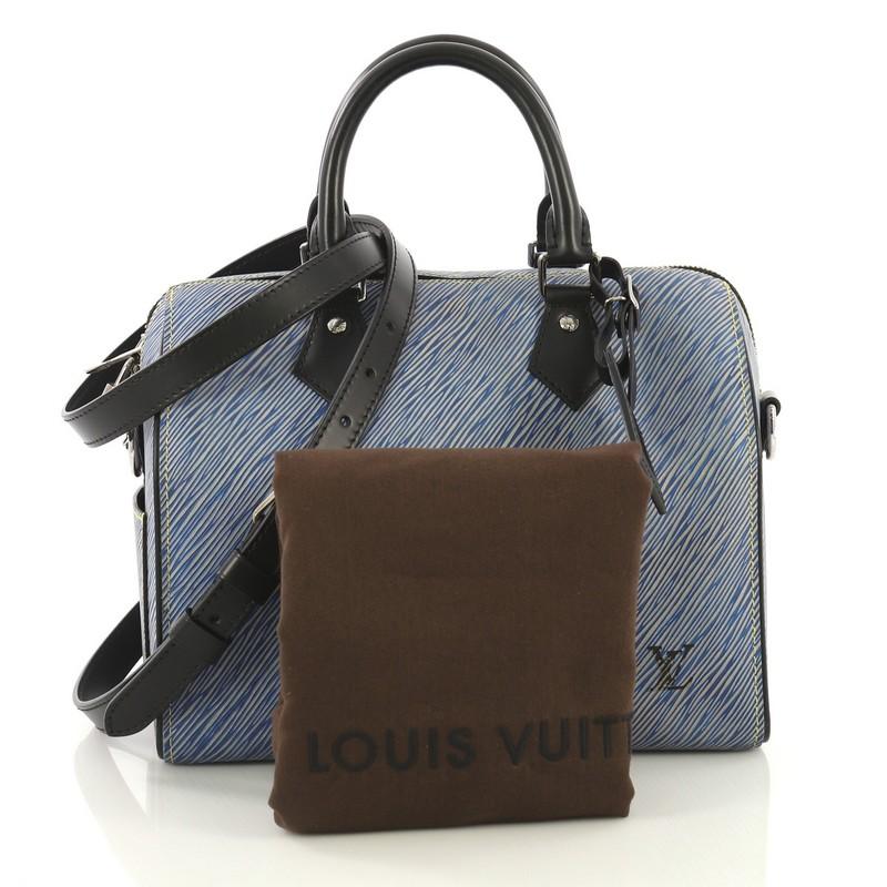This Louis Vuitton Speedy Bandouliere Bag Epi Leather 25, crafted from blue epi leather, features dual rolled leather handles, exterior side pocket, and silver-tone hardware. Its zip closure opens to a black microfiber interior with slip pockets.