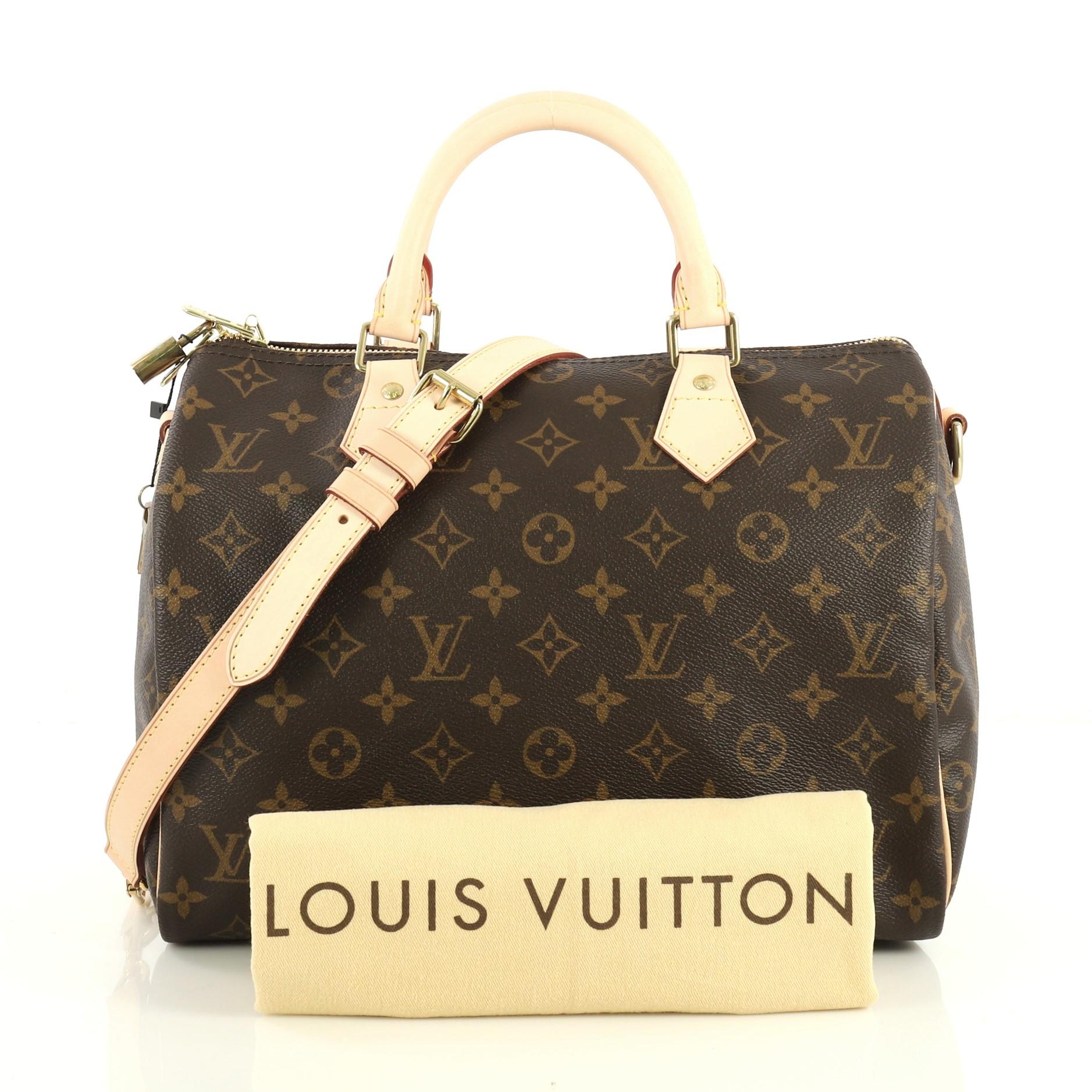 This Louis Vuitton Speedy Bandouliere Bag Monogram Canvas 30, crafted from brown monogram coated canvas, features dual rolled handles and gold-tone hardware. Its zip closure opens to a brown fabric interior with side slip pocket. Authenticity code