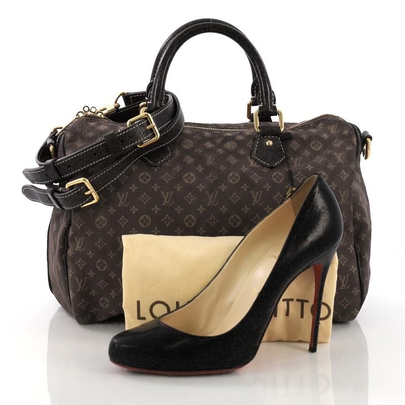 This Louis Vuitton Speedy Bandouliere Bag Monogram Idylle 30, crafted from brown monogram idylle canvas, features dual rolled top handles and gold-tone hardware. Its dual zip closure opens to a brown fabric interior with side slip pocket.