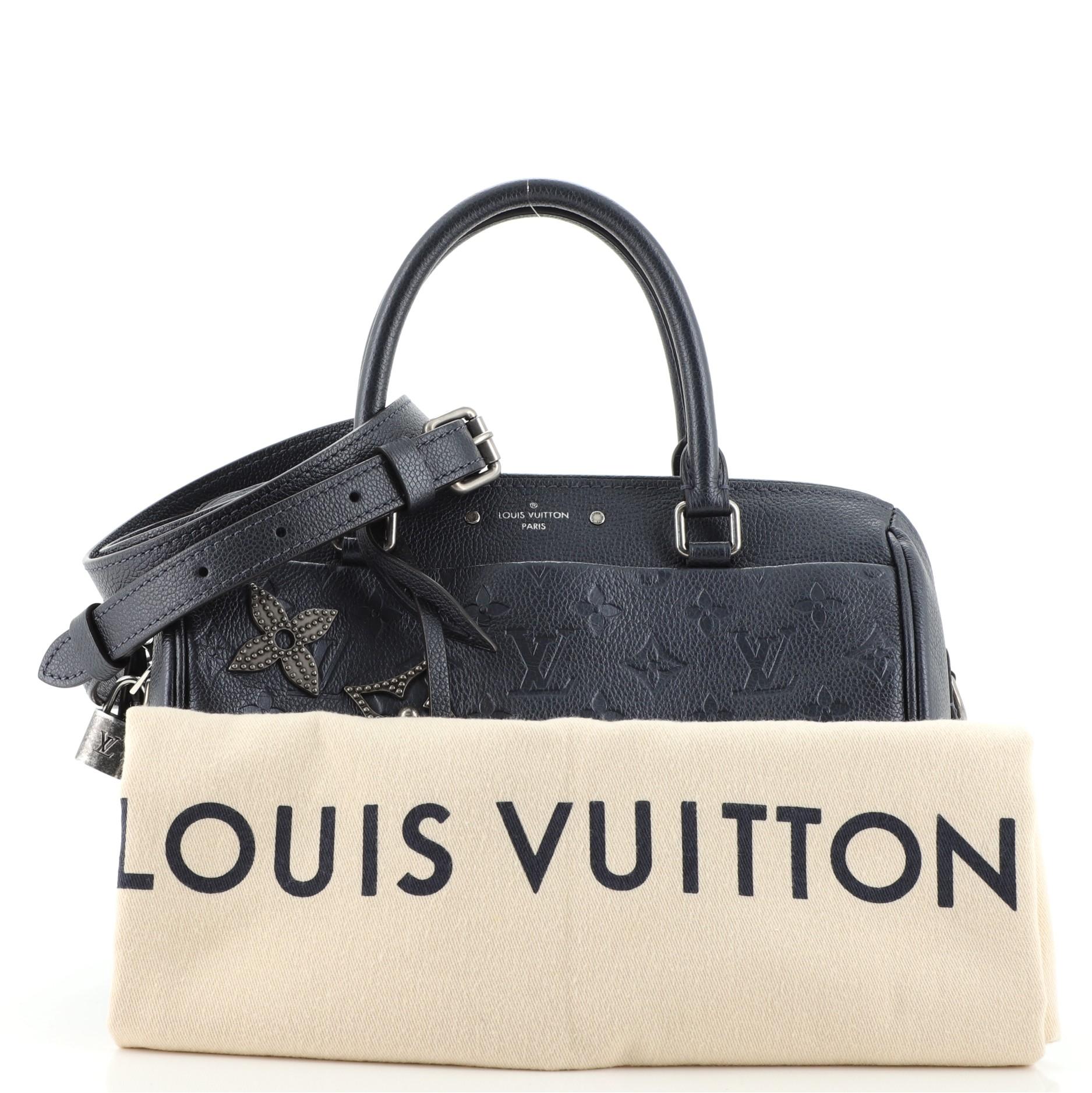 Condition: Very good. Odor in interior. Slight creasing on exterior and strap, wear on base corners, opening edges and handles, cracking on zipper pull wax edges. Minor wear and marks in interior, scratches on hardware.
Accessories: Lock, Dust Bag,