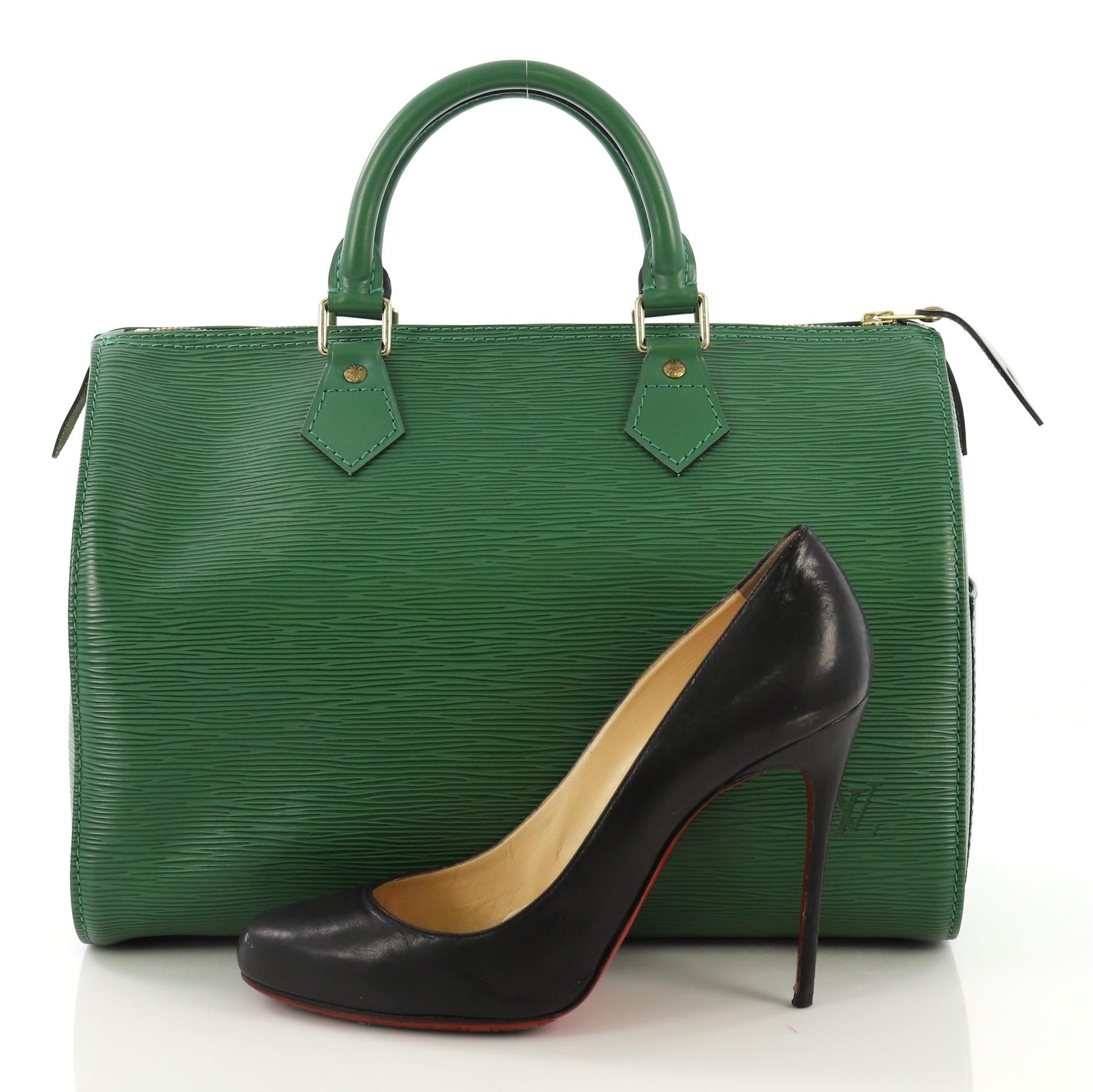This Louis Vuitton Speedy Handbag Epi Leather 30, crafted from green epi leather, features dual rolled leather handles, exterior side pocket, and gold-tone hardware. Its zip closure opens to a green raw leather interior with slip pockets. **Note: