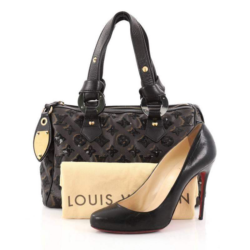 This authentic Louis Vuitton Speedy Handbag Limited Edition Monogram Eclipse Sequins 28 presented in the brand's Fall/Winter 2009 Collection updates the iconic Speedy with an enchanting and luxurious version. Crafted in stunning brown monogram