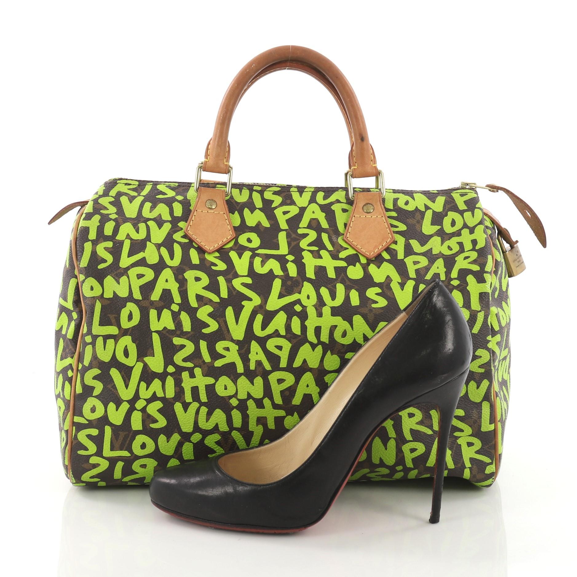 This Louis Vuitton Speedy Handbag Limited Edition Monogram Graffiti Canvas 30, crafted from green and brown limited edition monogram graffiti coated canvas, features cowhide leather handles and trims and gold-tone hardware . Its zip closure opens to