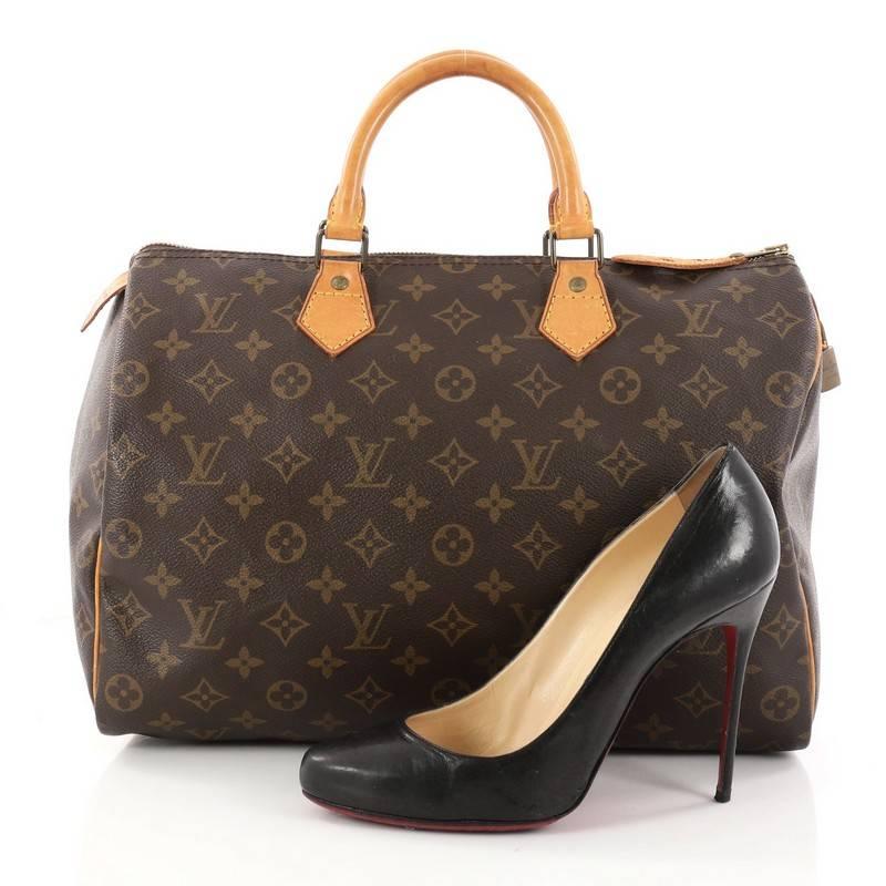 This authentic Louis Vuitton Speedy Handbag Monogram Canvas 35 is a classic must-have, making it ideal for everyday use. Constructed from Louis Vuitton's classic brown monogram coated canvas, this iconic Speedy features dual-rolled vachetta leather