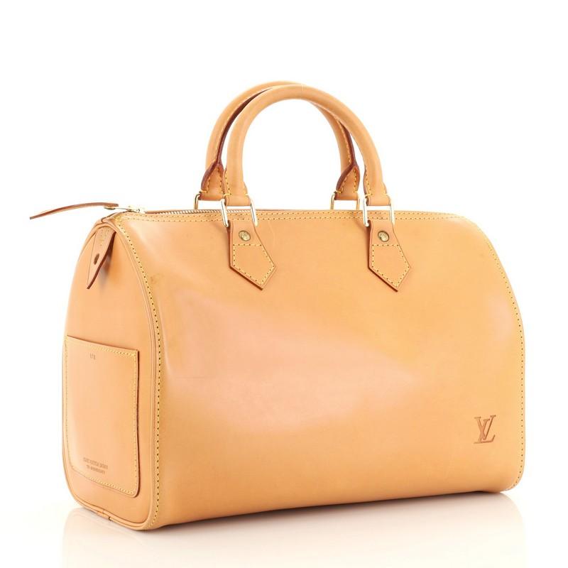 This Louis Vuitton Speedy Handbag Nomade Leather 30, crafted in neutral leather, features dual rolled leather handles, and gold-tone hardware. Its zip closure opens to a neutral suede interior. Authenticity code reads: VI1903 

Estimated Retail