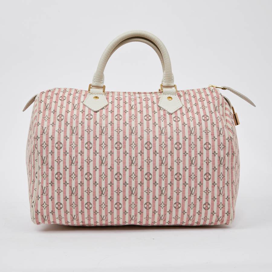 This Louis Vuitton Speedy bag is in mini Lin Monogram pink and gray. They created this new line of canvas, lighter but just as resistant. The trim is in gilt metal. The interior is in white canvas with a small patch pocket. It is carried by hand