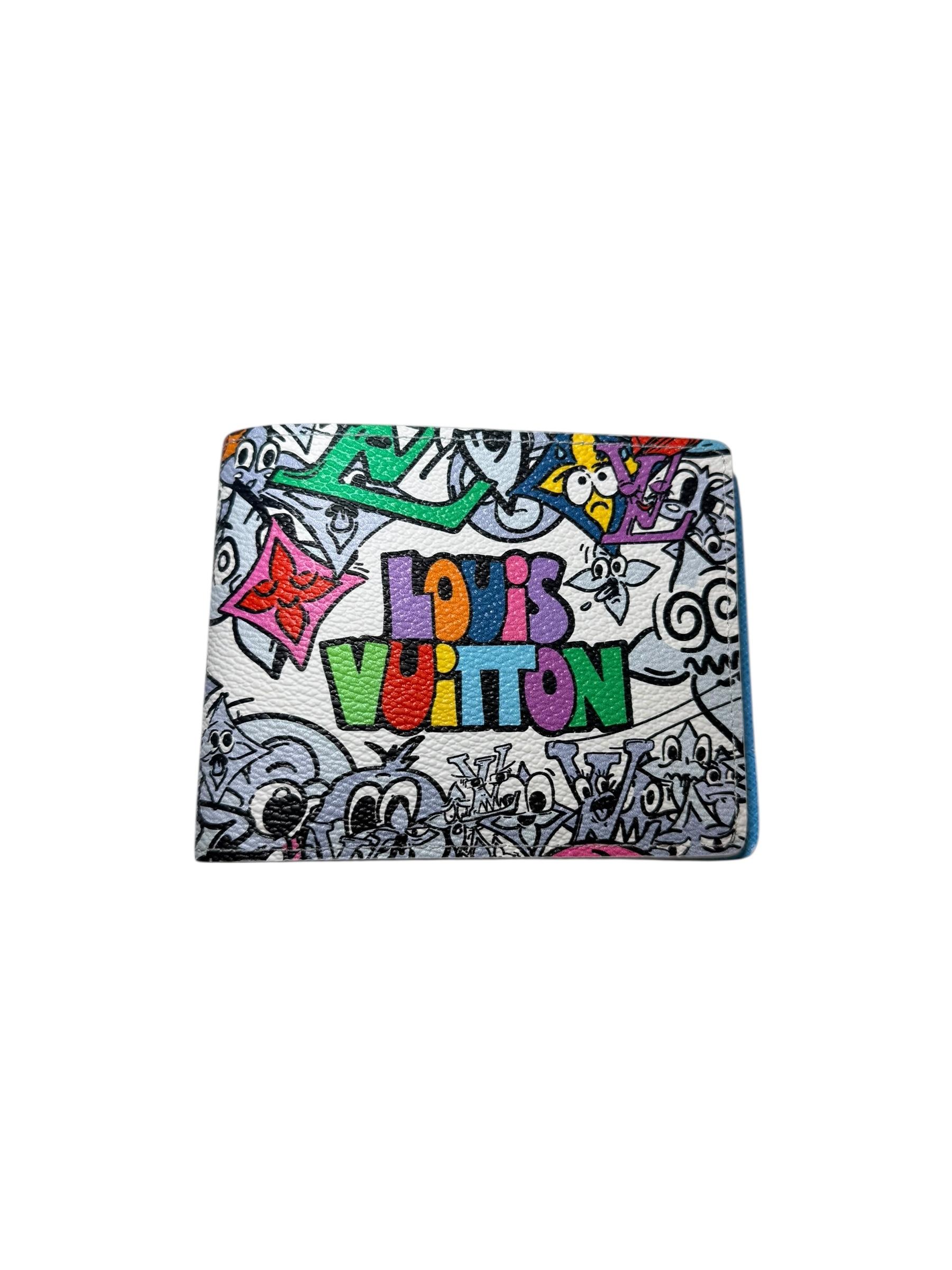 This rare Louis Vuitton SS23 Comics Multiple Wallet is a standout collectible from the Spring/Summer 2023 Men’s runway era. This was the last collection by Virgil Abloh before his untimely passing. The exterior features a lively multicolor animated