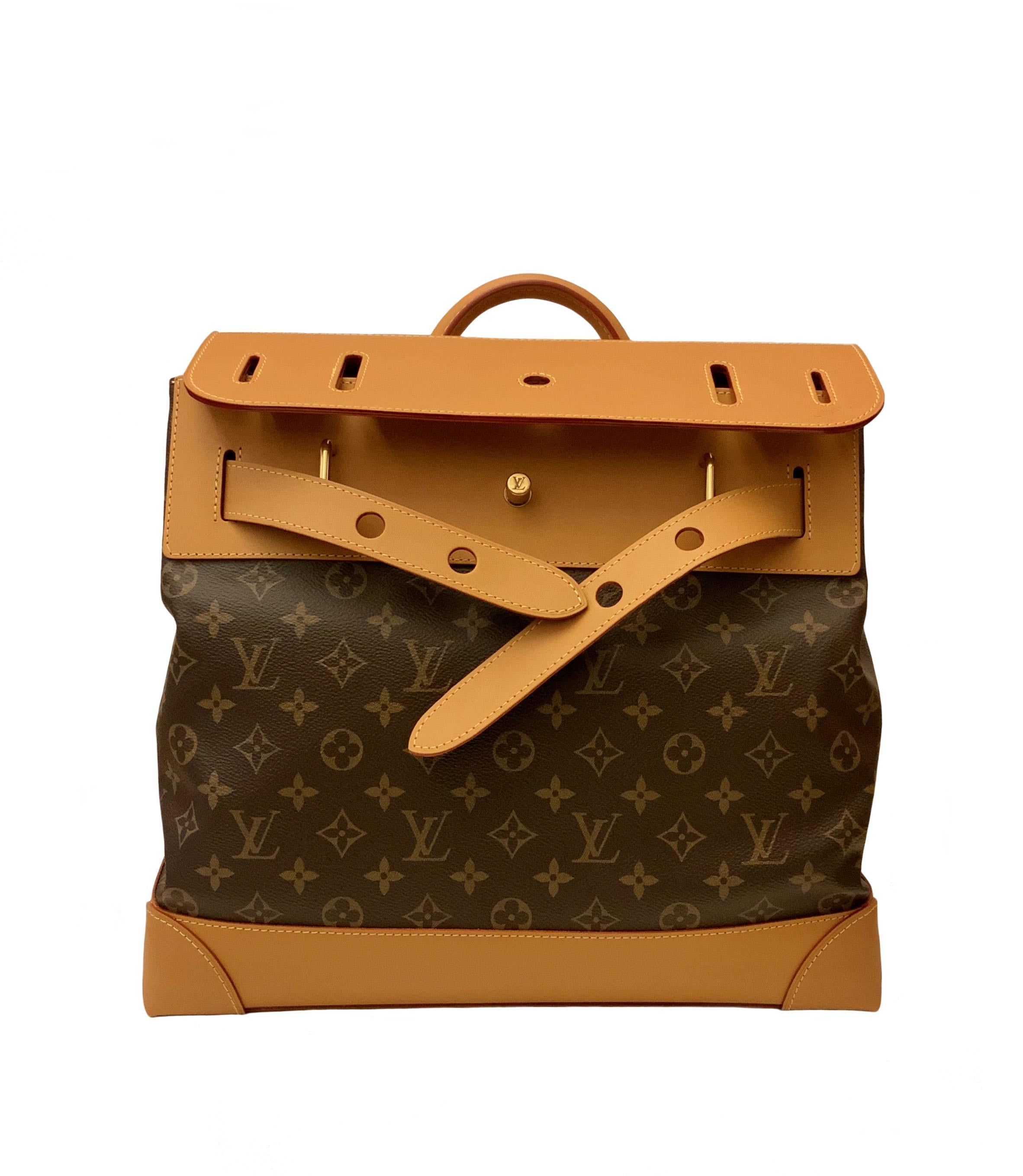 Created by Louis Vuitton in 1901, the Steamer has been redesigned by Virgil Abloh. 
It features a gold-tone chain and a safety pin as a closure in the front.
It is crafted in the classic Monogram canvas and the trimmings are in natural cow-hide