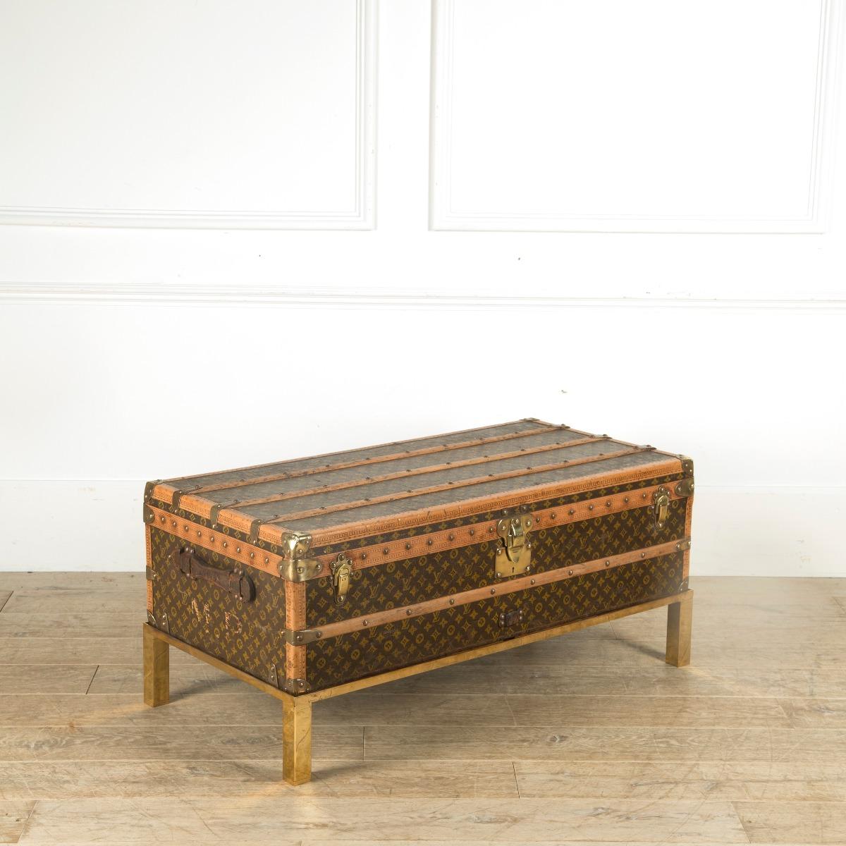 An immaculate 1930s Louis Vuitton cabin steamer trunk. In excellent condition retaining its original tray and label. Now sitting on a solid brass custom made stand, ideal coffee table height.