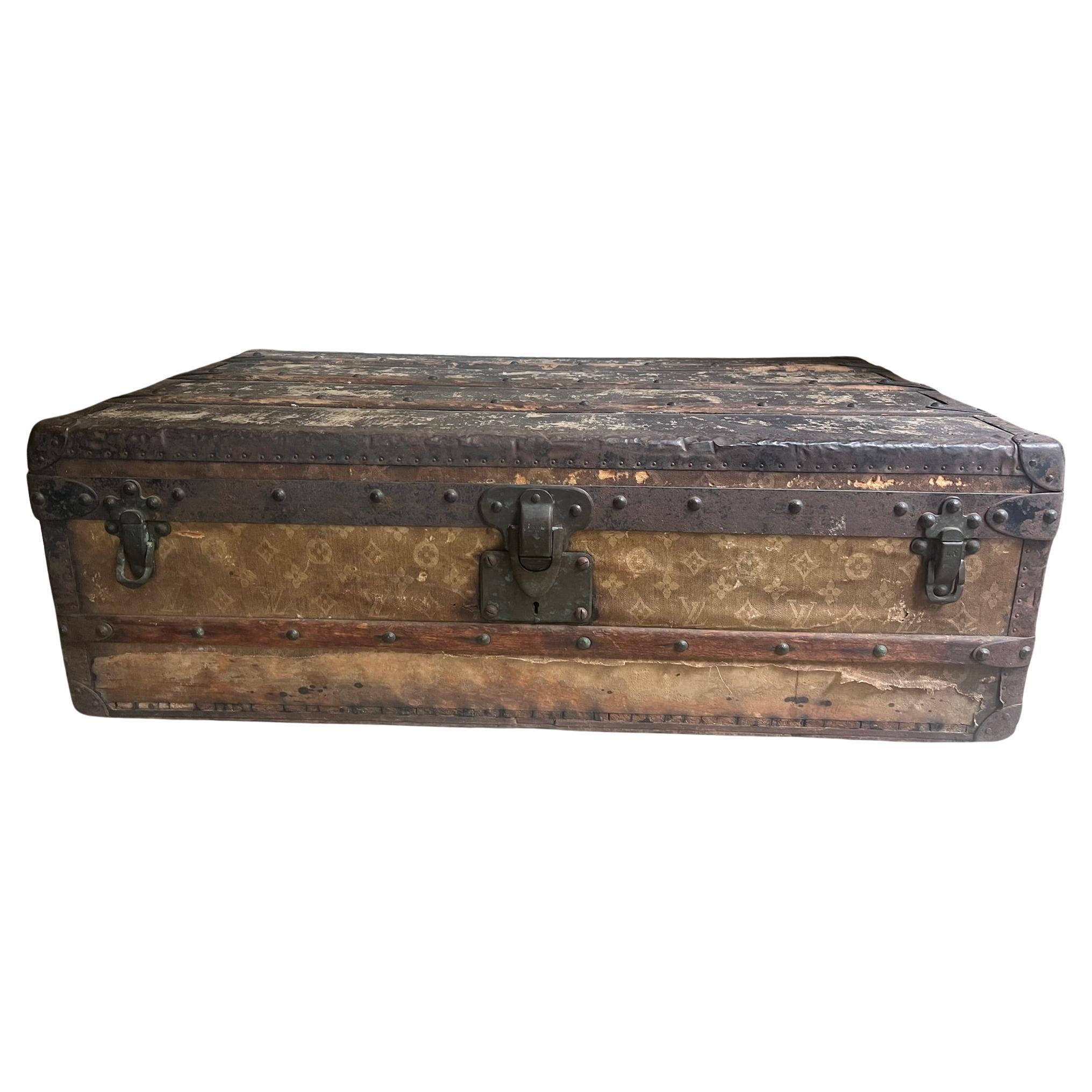 As found Louis Vuitton steamer trunk, in the traditional pattern of an intertwined LV with a floral motif.  The canvas is damaged or missing, all of the original hardware is intact. It may be missing an interior shelf.  I believe this steamer trunk
