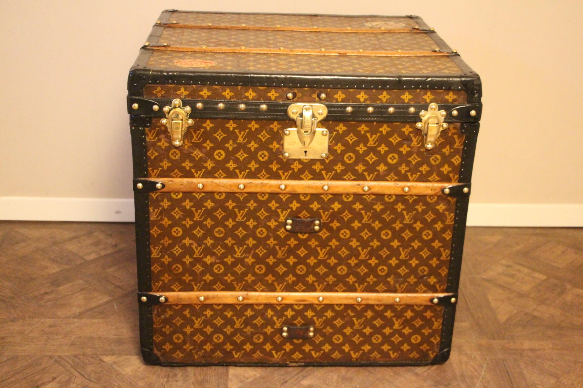 This unusual cube trunk is very elegant. It has got the stenciled LV monogram pattern canvas, blacklozine trim, LV stamped brass locks, LV stamped studs and black side handles. It features custom made painted stripes on each side and a couple of