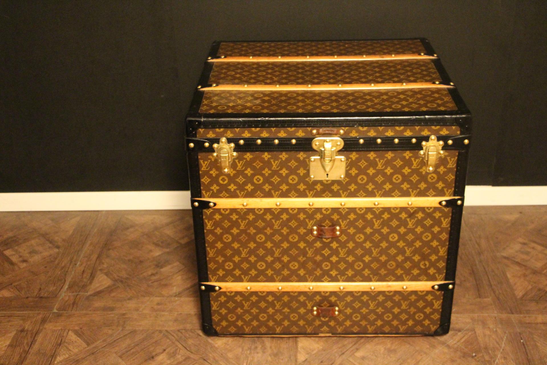This unusual cube trunk is very elegant. It has got the stenciled LV monogram pattern canvas, blacklozine trim, LV stamped brass locks, LV stamped studs and black side handles. It features custom made painted flag on each side and a couple of travel