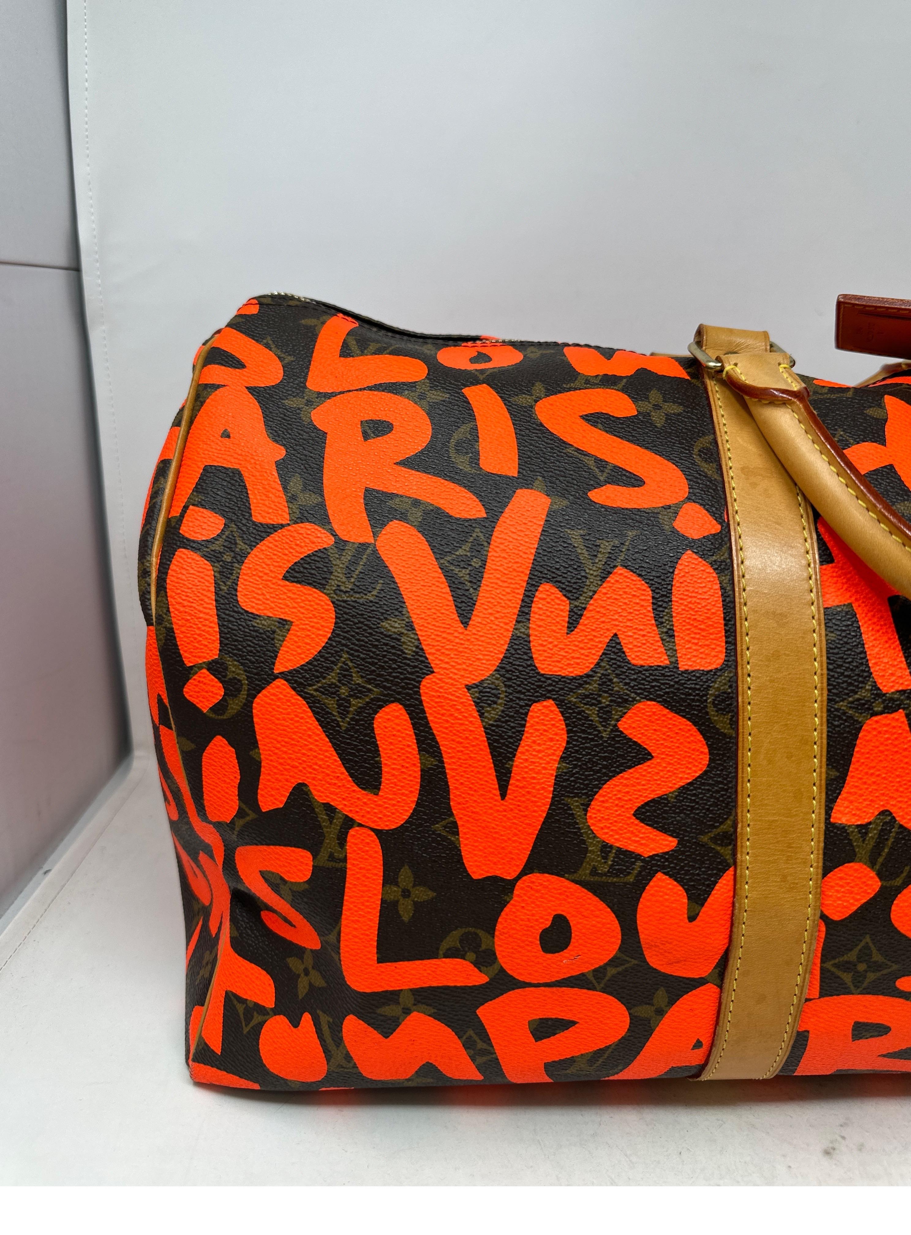 Louis Vuitton Orange Graffiti Keepall 50 Bag. Stephen Sprouse designed for Louis Vuitton duffle. Good condition. Light wear from normal use and age. Overall good condition. Interior clean. Light water mark inside. See photos please. Rare and iconic