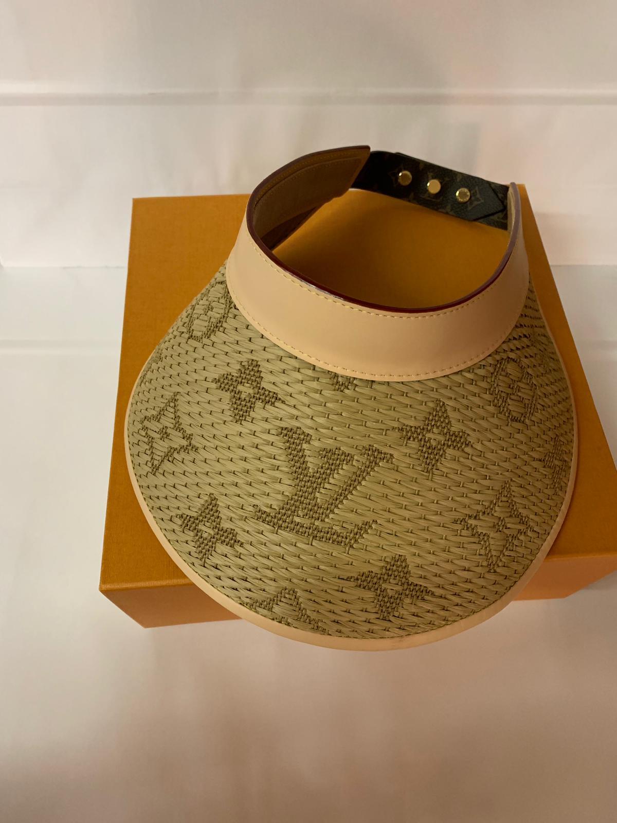 Louis Vuitton Strawgram, raffia visor with monogram closure.
One size with original box.