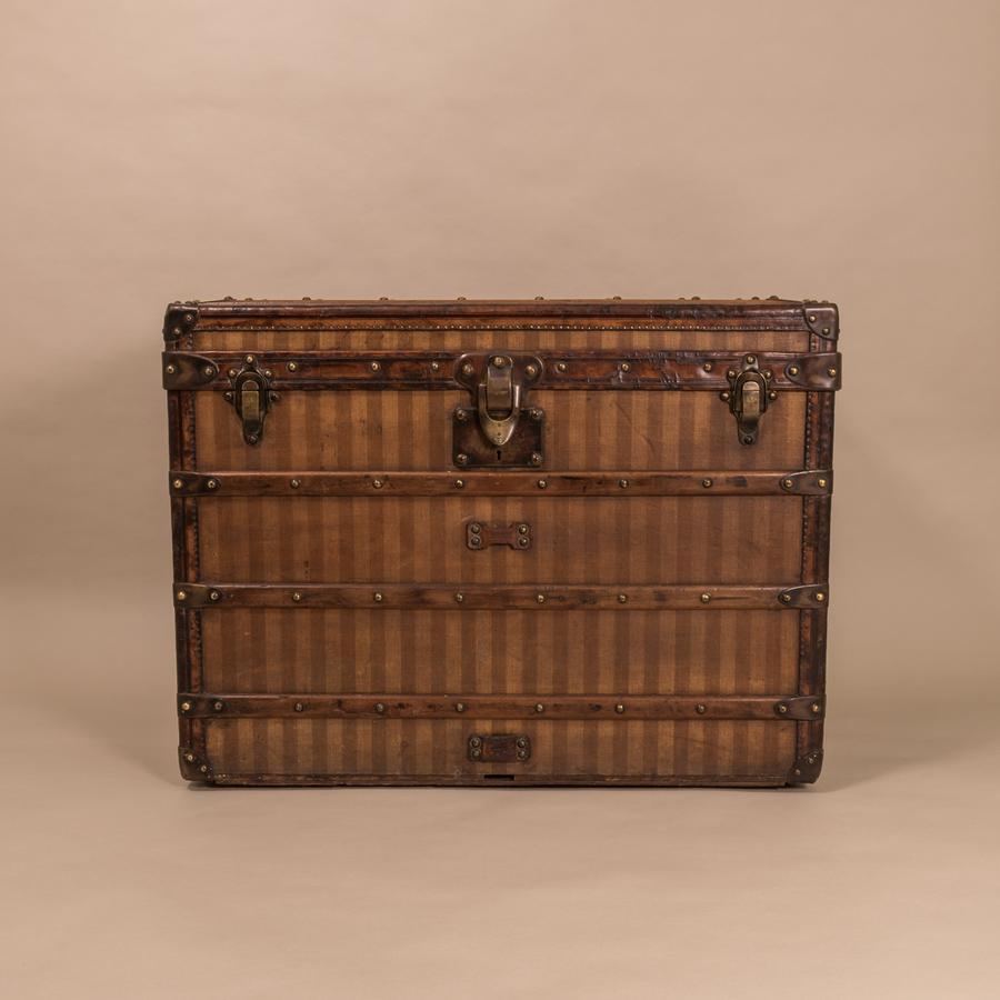 A rare Louis Vuitton striped canvas trunk with leather trim and brass fittings; Circa 1890. With excellent original interior retaining it’s trays plus the original ribbon to the inside of the lid mimicking the French tricolouré. In 1876 Louis