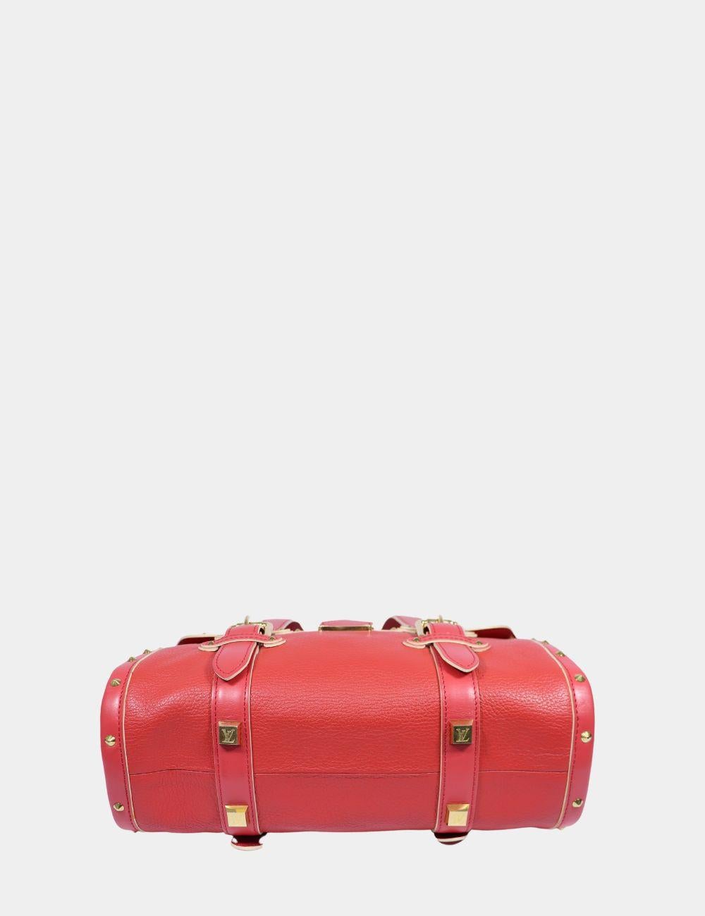 Turn heads with this rare and luxurious Louis Vuitton Suhali L’Ingenieux PM handbag in vibrant red goat leather. This structured satchel features rich gold-tone hardware, buckle detailing, and signature S-lock closure at the front. Crafted in Louis