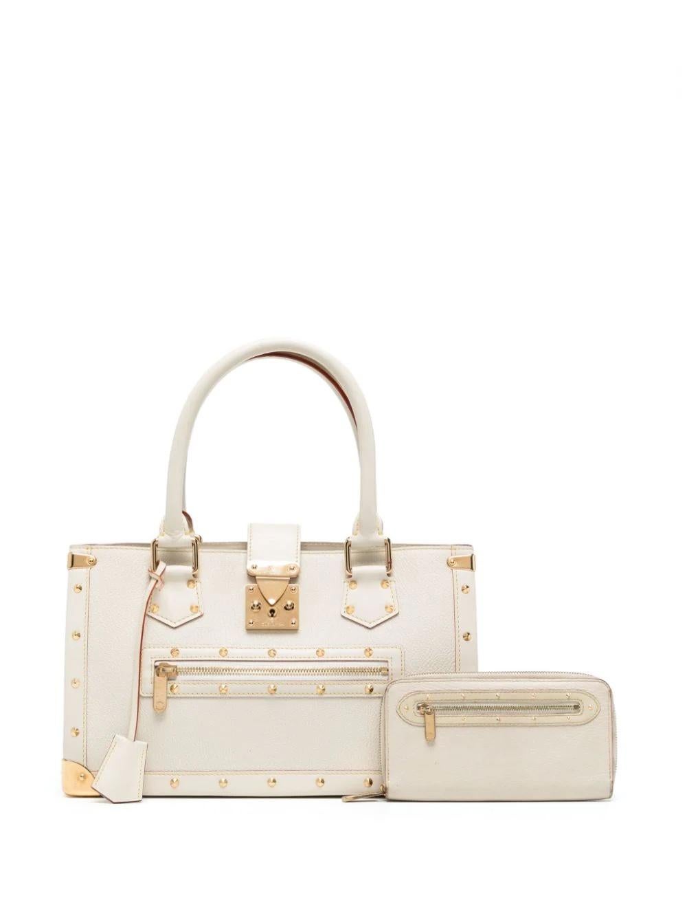 * White calf leather
* Clochette
* Gold-tone stud detailing
* Two rolled top handles
* Clasp fastening
* Partitioned compartment
* Removable matching wallet
* Multiple internal slip pockets
* Very Good Condition: This pre-loved item does show minor