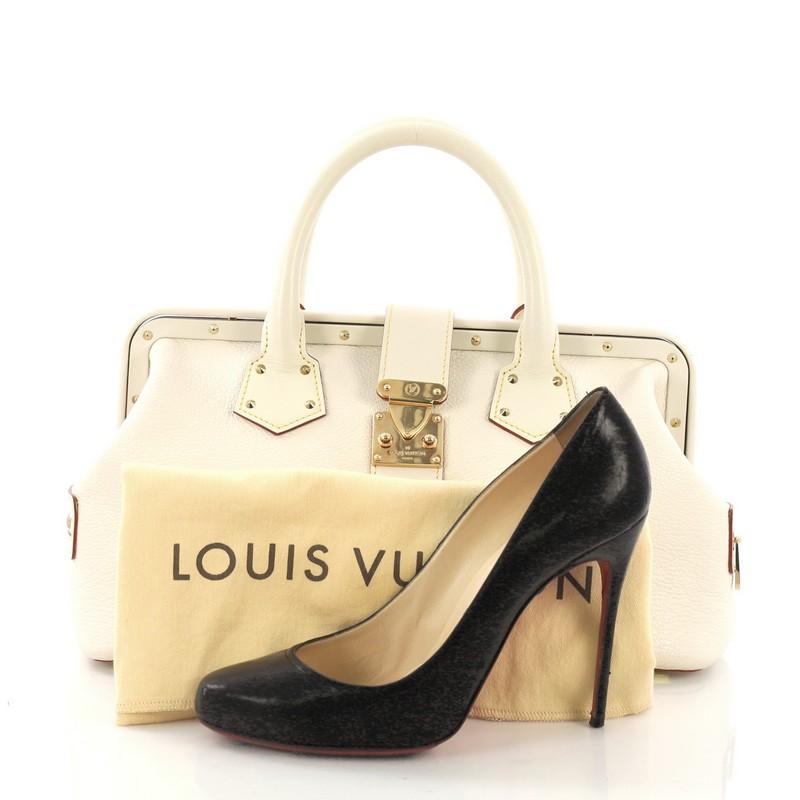 This Louis Vuitton Suhali L'ingenieux Handbag Leather PM, crafted from off-white leather, features dual rolled leather handles, stud accents, a top buckle and press lock closure, and gold-tone hardware. Its frame top and press-lock closure opens to