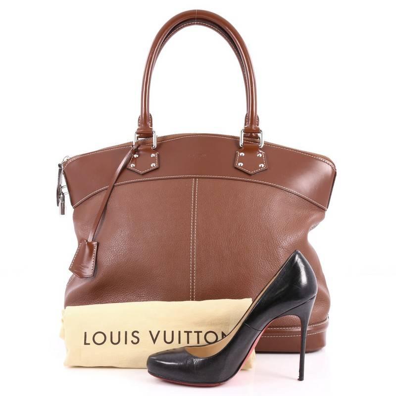 This authentic Louis Vuitton Suhali Lockit Handbag Leather MM is updated to the present, borrowing from its 1958 original design with a modern twist. Crafted from brown suhali leather, this functional tote feature dual-rolled handles, brown leather