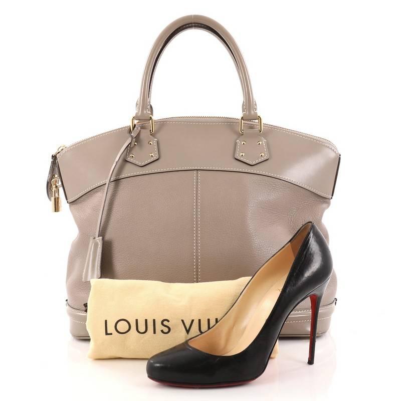 This authentic Louis Vuitton Suhali Lockit Handbag Leather MM is updated to the present borrowing from its 1958 original design with a modern twist. Crafted from light taupe suhali leather, this functional tote feature dual-rolled handles, sturdy