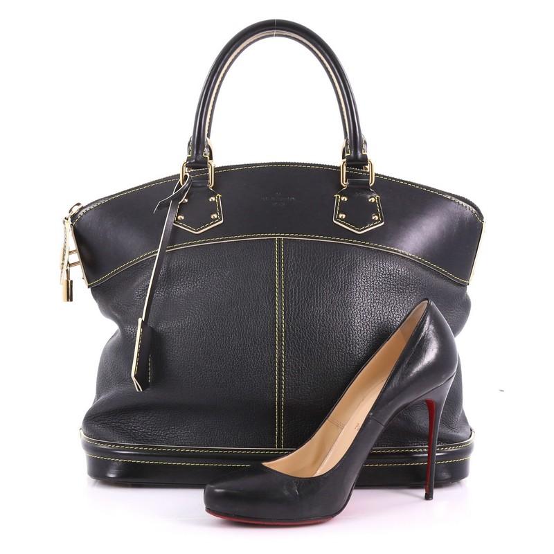 This Louis Vuitton Suhali Lockit Handbag Leather MM, crafted from black leather, features dual rolled handles, standout contrast stitching, and gold-tone hardware. Its top zip closure opens to a black fabric interior with side zip pocket.