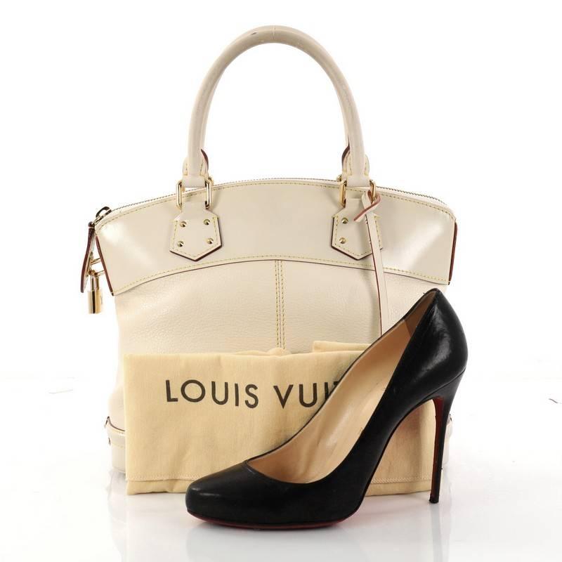This authentic Louis Vuitton Suhali Lockit Handbag Leather PM is updated to the present, borrowing from its 1958 original design with a modern twist. Crafted from cream suhali leather, this functional tote feature dual-rolled handles, cream leather