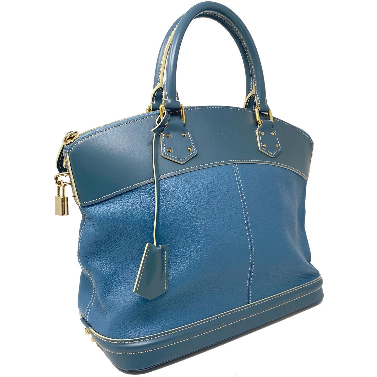 Company-Louis Vuitton 
Style-Suhali MM Lockit Blue Leather Tote Handbag  
Outside -No rips, tears or stains
Inside-No Rips , tears or stains  
Pockets-Interior pockets only 
Handles/ Straps-5