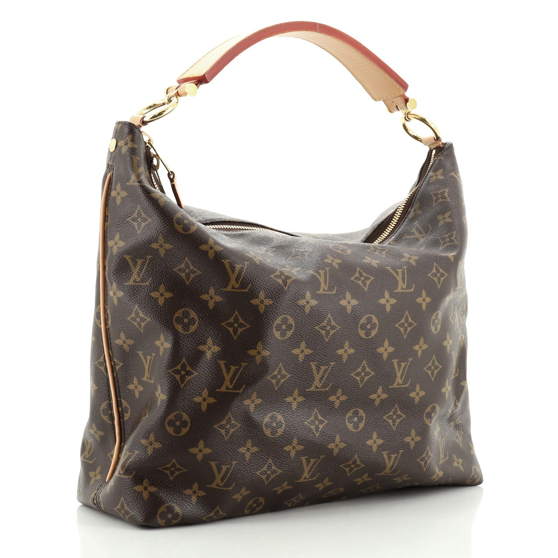 This Louis Vuitton Sully Handbag Monogram Canvas MM, crafted from brown monogram coated canvas, features a thick vachetta cowhide looped strap and gold-tone hardware. Its two-way zip closure opens to a brown fabric interior with slip pockets.