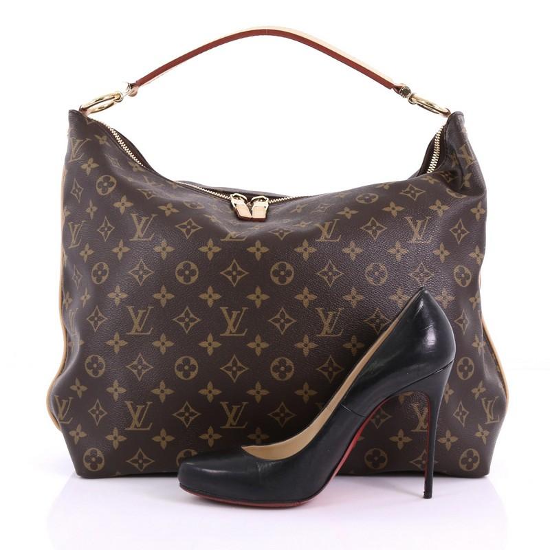 This Louis Vuitton Sully Handbag Monogram Canvas MM, crafted from brown monogram coated canvas, features a thick vachetta cowhide looped strap and gold-tone hardware. Its two-way top zip closure opens to a brown fabric interior with slip pockets.