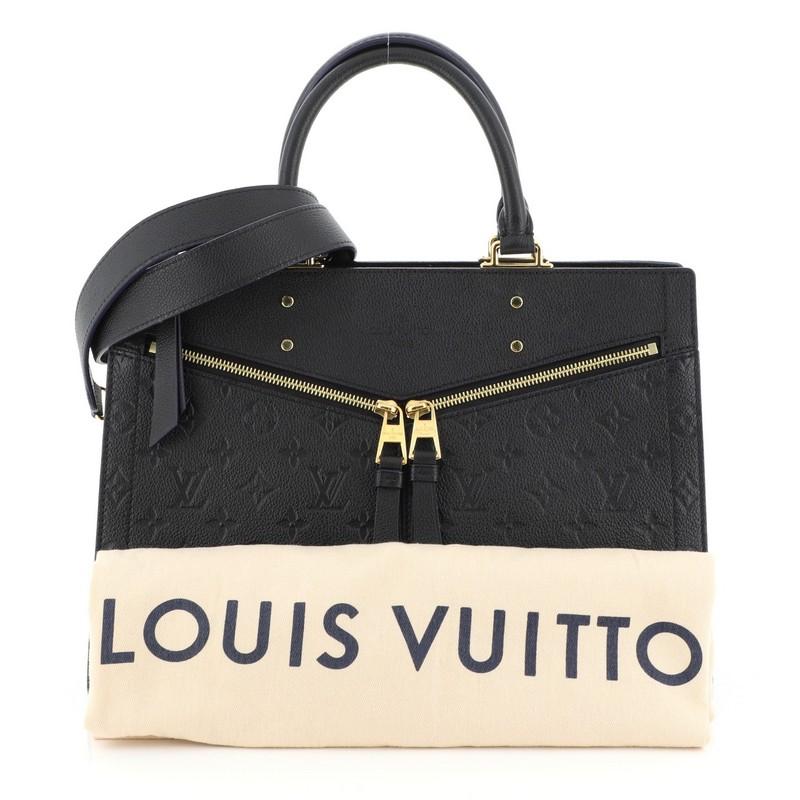 This Louis Vuitton Sully Handbag Monogram Empreinte Leather MM, crafted from black monogram empreinte leather, features dual rolled handles, exterior front zip pockets and gold-tone hardware. Its top zip closure opens to a black fabric interior with