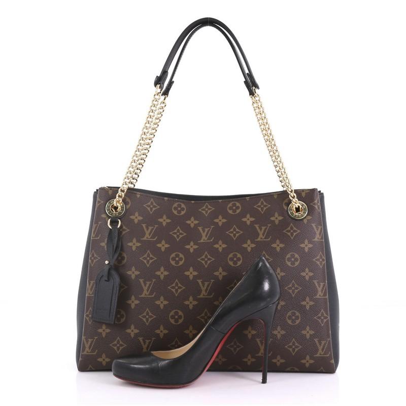 This Louis Vuitton Surene Handbag Monogram Canvas with Leather MM, crafted from brown monogram coated canvas with black leather, features dual chain link straps with leather pads and gold-tone hardware, It opens to a black microfiber interior with