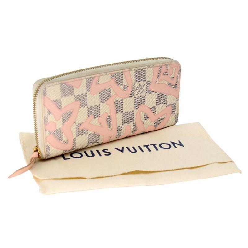 Louis Vuitton Tahiti GM Clemence Leather Round Wallet LV-1104P-0010

This is a extremely rare and unique wallet crafted of traditional Louis Vuitton Azur monogram with check toile canvas with large pink monogram logos. A 3/4 wrap around gold zipper