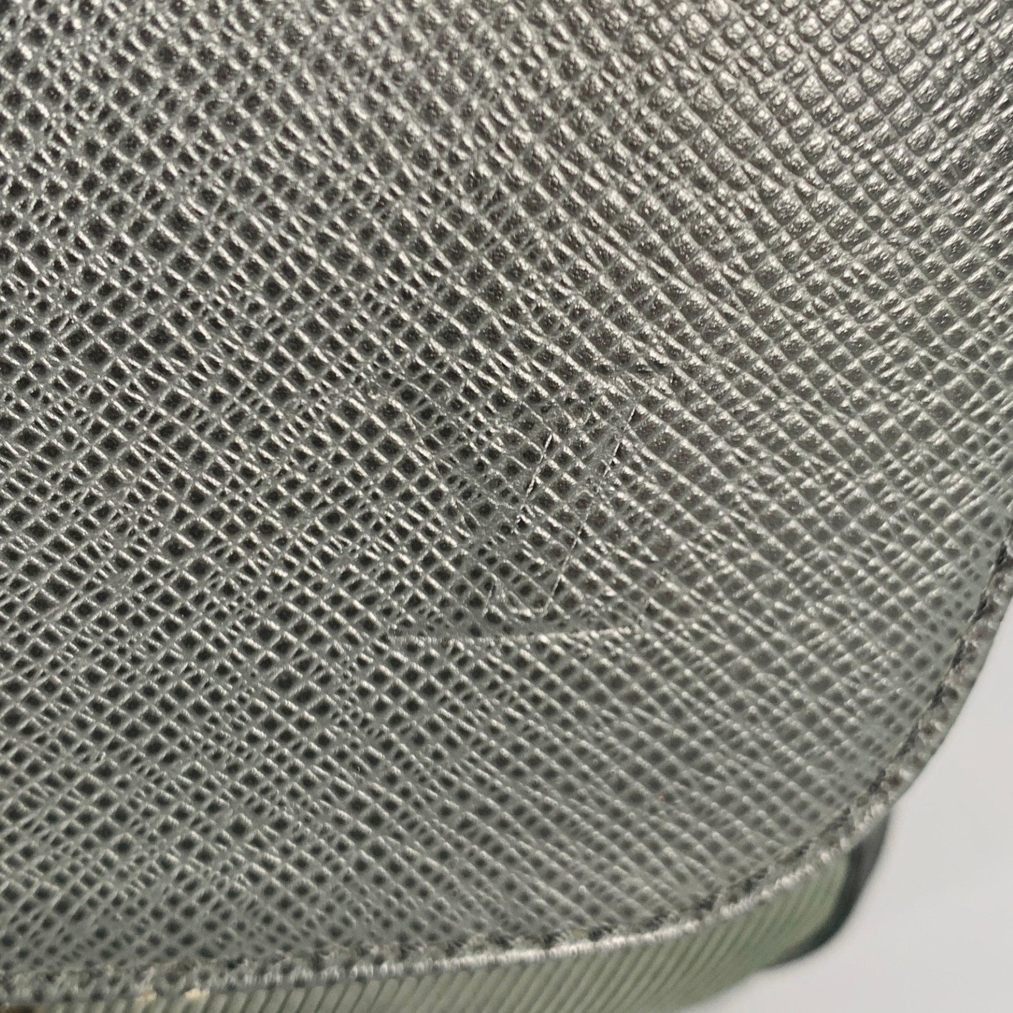 LOUIS VUITTON -Taiga Dersou- bag
in a dark green leather featuring a messenger bag style with black nylon straps, spacious storage, and fisherman's toggle closure. Comes with dust bag. Made in Italy.Excellent Pre-Owned Condition. 

Marked:  