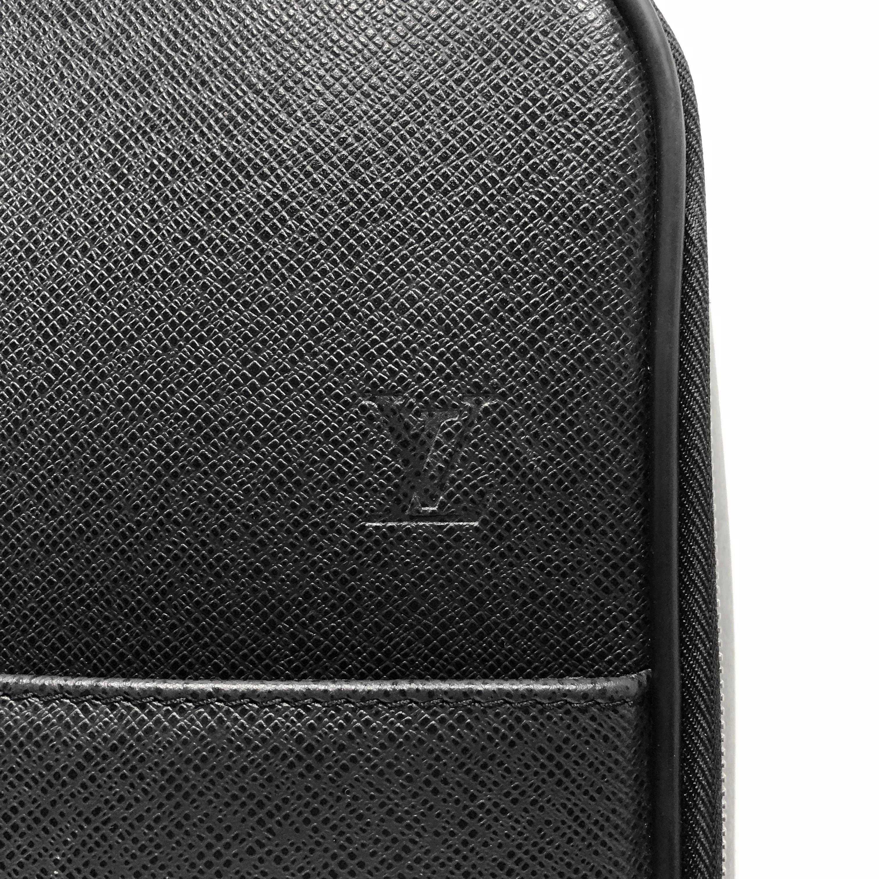 Louis Vuitton dark grey taiga leather Pegase 45 with silver-tone hardware, flat pocket at front, retractable pull handle, wrap around zipper. The interior primary compartment is lined with a durable black nylon and pockets, and a removable pouch.