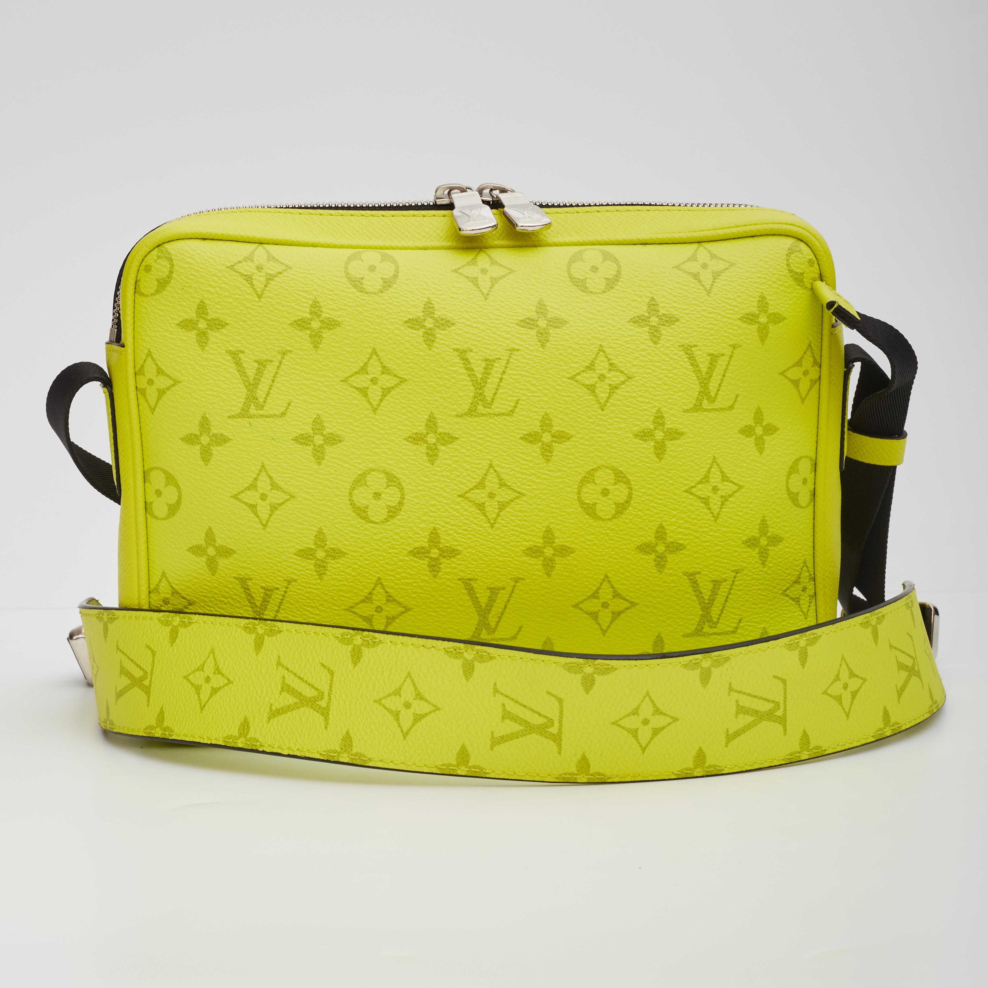 Louis Vuitton Messenger Bag. From the 2019 Collection. Yellow Taiga Leather. LV Monogram. Silver-Tone Hardware. Single Adjustable Shoulder Strap. Single Exterior Pocket. Canvas Lining & Single Interior Pocket. Zip Closure at Top.

Color: